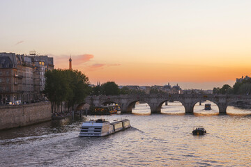 View of Paris from the Seine River on a summer evening at sunset. Paris in the rays of the setting sun
