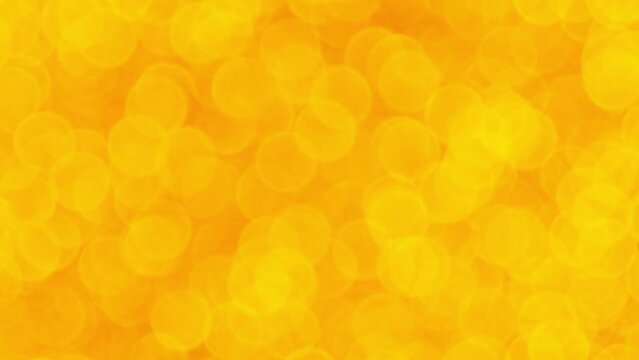 Abstract shiny yellow golden glitter HD video background. Golden glitter background with sparkling texture. Scale on gold shimmering light, sequins sparks and glittering glow foil background.
