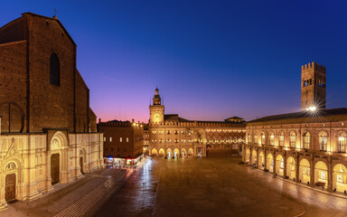 Sunset light bathes Piazza Maggiore in Bologna, highlighting the grandeur of its medieval...