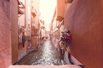 A romantic view from a window festooned with padlocks, overlooking the tranquil Canale delle Moline...