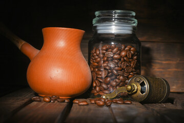 Coffee beans and coffee grinder on the kitchen table close up background. Front view.