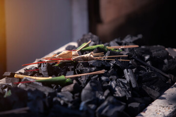 The crematory tray with incense sticks, flower and charcoal from cremate funeral human body cremation ceremony of religion buddhist in temple of Thailand.  - obrazy, fototapety, plakaty