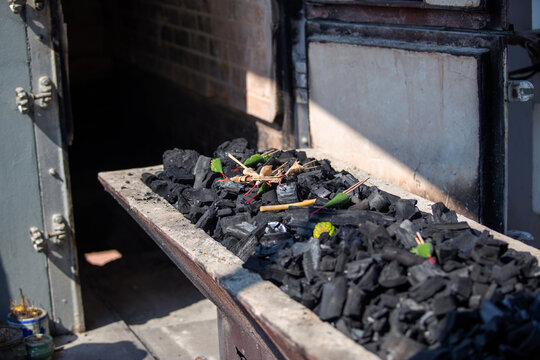 The crematory tray with incense sticks, flower and charcoal from cremate funeral human body cremation ceremony of religion buddhist in temple of Thailand. 