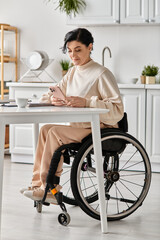 A disabled woman in a wheelchair works remotely from her kitchen, using a laptop to stay connected and productive.