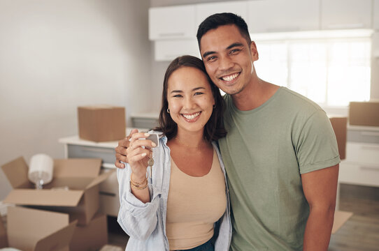 Portrait, couple and happy in new home with boxes for moving in, satisfied and confident with ownership. Real Estate, relationship and smile with unpacking furniture, excited and positive on property