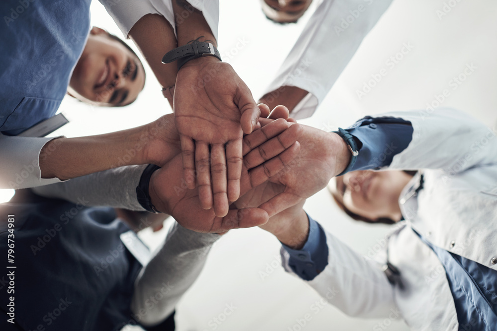 Poster Low angle, hands and stack with doctors, hospital and cooperation with teamwork, support and healthcare. Below, medical and professional with group, collaboration and schedule with goals and trust