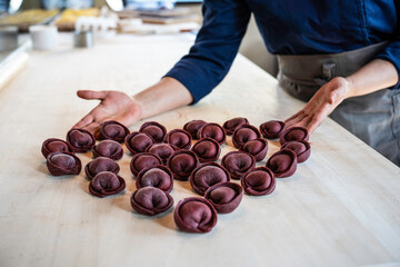 Artisanal beetroot tortelli arranged with love, a culinary heart in Italian cuisine. A chef's touch brings a gourmet creation to life, crafting with passion and precision.