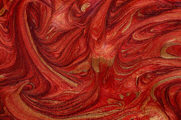 Closeup of red fluid metallic paint textured background