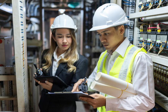 In the dynamic energy industry, the power plant is a vital hub where male and female engineers collaborate to optimize energy production and efficiency.