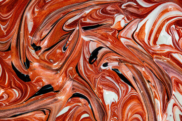 Closeup of red fluid metallic paint textured background