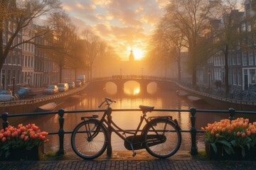 b'A bicycle parked on a bridge in Amsterdam with a beautiful sunrise in the background'