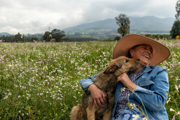 Senior woman enjoying a day in the countryside with her dog