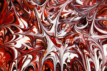 Closeup of red fluid metallic paint textured background