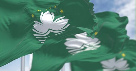 Close-up of Macau flags waving on a clear day