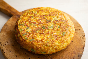 Spanish potato omelet with cauliflower and vegetables. Traditional Spanish tapa recipe.