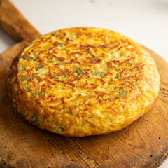 Spanish potato omelet with cauliflower and vegetables. Traditional Spanish tapa recipe.