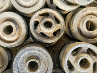 Old stacked rollers used in agricultural equipment covered with dust