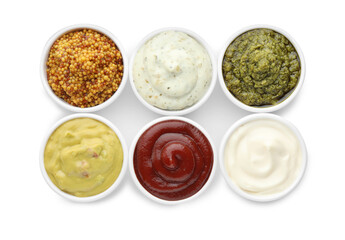Many different sauces in bowls on white background, top view