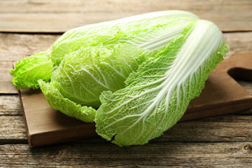 Fresh ripe Chinese cabbage on wooden table, closeup - obrazy, fototapety, plakaty