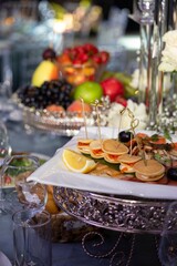 Elegant catering banquet table with assorted appetizers and fruit platter