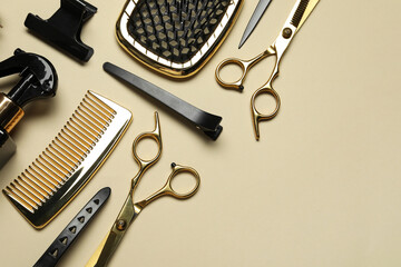 Different hairdresser tools on beige background, flat lay. Space for text