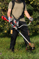 Man holding a trimmer ready for yard work