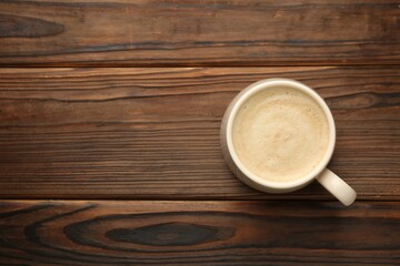 Cup of coffee on wooden table, top view. Space for text - obrazy, fototapety, plakaty