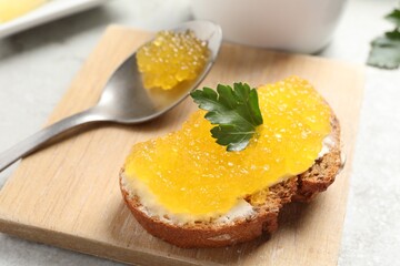Tasty sandwich with pike caviar and parsley on table, closeup