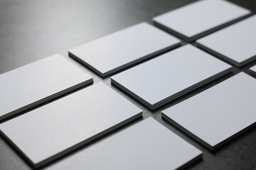 Blank business cards on grey textured table, closeup. Mockup for design