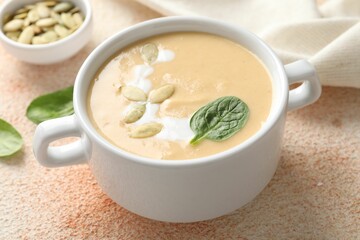 Healthy cream soup high in vegetable fats on color textured table, closeup