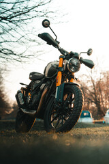 Obraz na płótnie Canvas Scrambler motorcycle at sunset, cafe racer style retro motorbike wallpaper