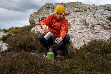 happy hiker in nature serves freshly brewed coffee with stovetop coffee maker