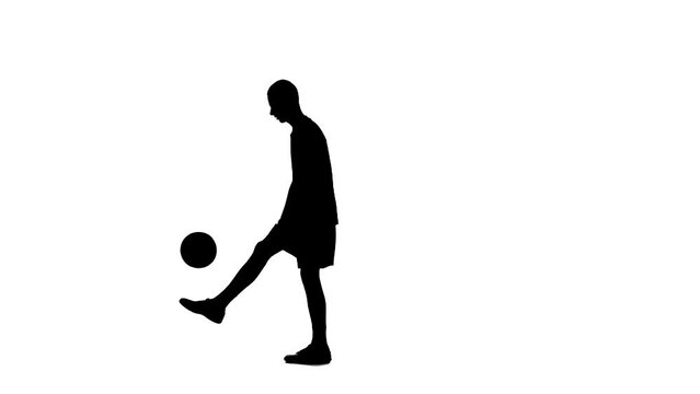 Silhouette of a football player isolated on a white background with an alpha channel. A man, a professional soccer player, is kicking a ball.