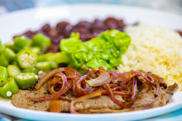 Traditional rustic Brazilian lunch, beans, rice, steak, okra and lettuce. Executive made dish
