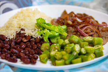Traditional rustic Brazilian lunch, beans, rice, steak, okra and lettuce. Executive made dish