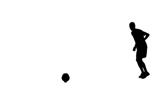 Soccer player silhouette isolated on white background with alpha channel. Man professional football player catching ball and making strike away from camera.