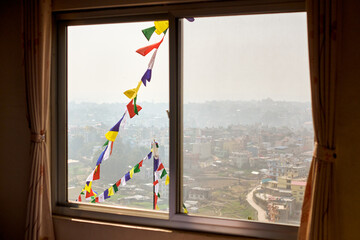 View of Kathmandu from hotel window through urban haze with lot of low rise buildings, cityscape...