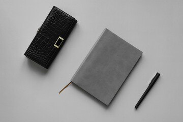 flat lay business layout notepad and wallet on gray background