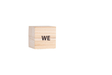 wooden cubes with the inscription We on a white isolated background close-up