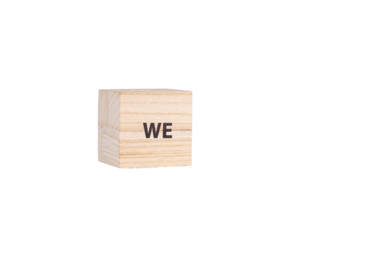 wooden cubes with the inscription We on a white isolated background close-up