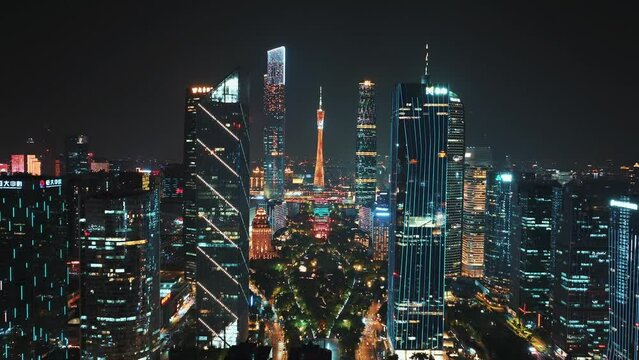 Guangzhou's skyline and iconic tower lit in neon colors against the night sky
