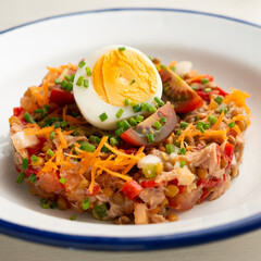 Summer salad with lentils, vegetables and boiled egg.