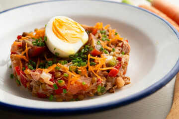 Summer salad with lentils, vegetables and boiled egg.