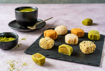 Variety of Mochi on Slate with Matcha Tea Side View
