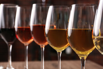 Obraz premium Different tasty wines in glasses against blurred background