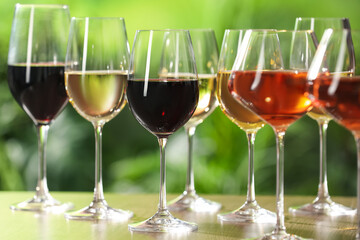 Fototapeta premium Different tasty wines in glasses on table