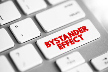 Bystander Effect ( social psychological theory) occurs when the presence of others discourages an individual from intervening in an emergency situation, text concept button on keyboard - 796842778