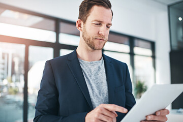 Fototapeta premium Businessman, tablet and internet research as tech startup or project planning or game design, digital app or office. Male person, scrolling and finger or programming software, entrepreneur or contact