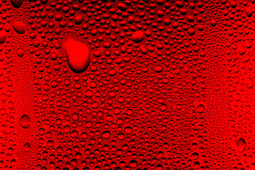 Red close-up macro drink water drop surface,Water droplets on a glass of red cold drink for background and texture. (close up, selective focus, space for text)
