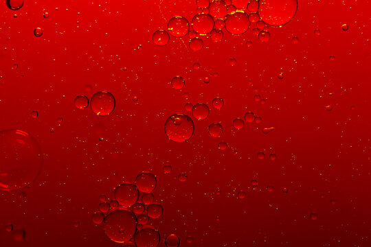 Macro red bubble texture close-up,red macro bubbles,Backgrounds, Abstract Backgrounds, Soda, Red, Carbonated,Beauty concept background. Closeup cosmetic liquid gel with bubbles on red colors backgroun